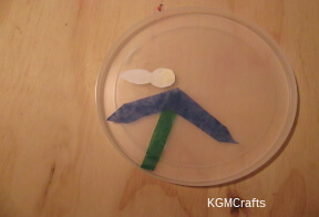 place the stem and some flower petals then the bee