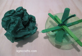 step 6 secure Popsicle sticks and make a ball of tissue