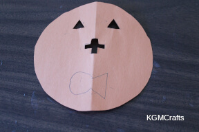 cut out the eyes and draw the mouth