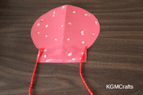 cut yarn and glue to back of balloon love God neighbor step 5