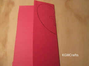 step 2 draw half of a heart and cross on red paper