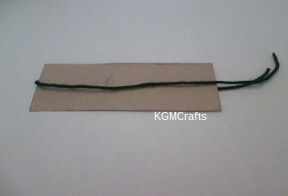 wrap a cut piece of yarn around cardboard