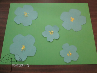 blue flowers on green background field of paper flax flowers