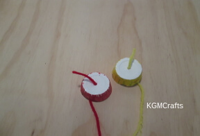 thread yarn through hole in cup