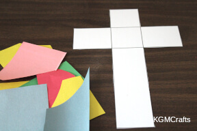 give child paper and a cross torn paper cross step 1