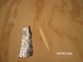 cut a piece of cardboard in a needle shape