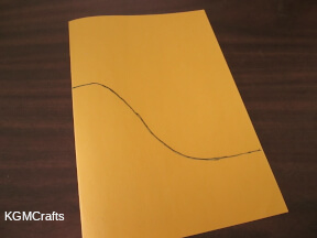 fold the paper and draw a hill shape