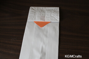 add one part of the beak under the flap of the bag