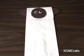 glue the pieces to the bag to make a sheep