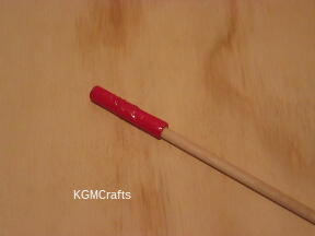 step 2 cover one end of a dowel with duck tape