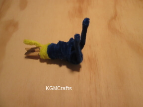 step 3 use a yellow pipe cleaner in the center of the clothespin