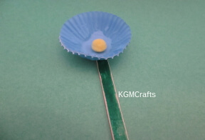 glue on pompom to liner and liner to stick