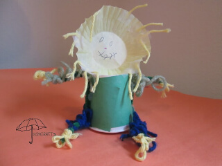 Make a scarecrow with a paper cup, cupcake liner,and yarn cup scarecrow