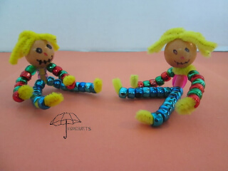 2 beaded scarecrow dolls sitting beaded scarecrow