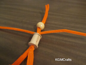 add a pipe cleaner between the bead and spool