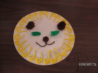 yellow, brown, green yarn used to make lion Yarn paper plate lion