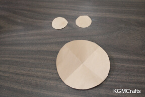 cut two small circles and one larger circle from brown paper