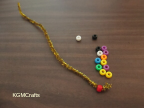 add the red bead to the pipe cleaner