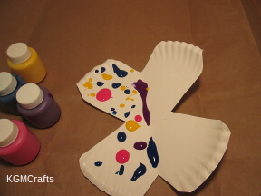 step 2 add drops of paint to on of the butterfly's wings