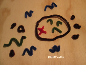 bend your pipe cleaners to represent an island, hills, etc.