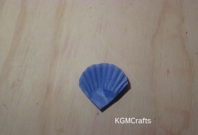 step 3 fold a cupcake liner and round the edges