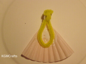 glue the pipe cleaner to the skirt