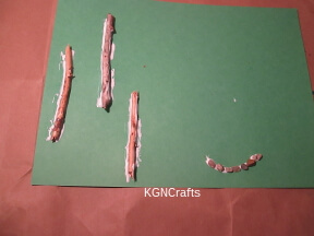add sticks and rocks to construction paper