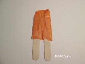 wrap the tissue around the Popsicle sticks