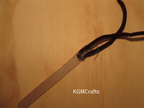 step 1 hot glue the hook and pipe cleaner to the craft stick