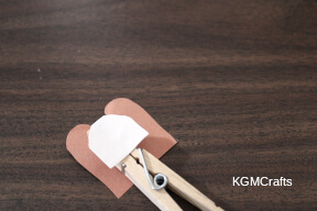 glue the baby to the back of the clothespin