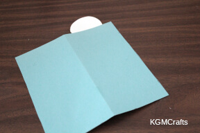 glue the circle to the top of the folded rectangle