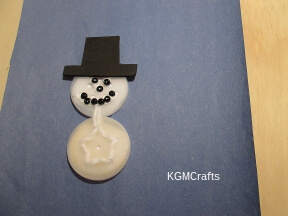 glue the bead and hat to the snowman