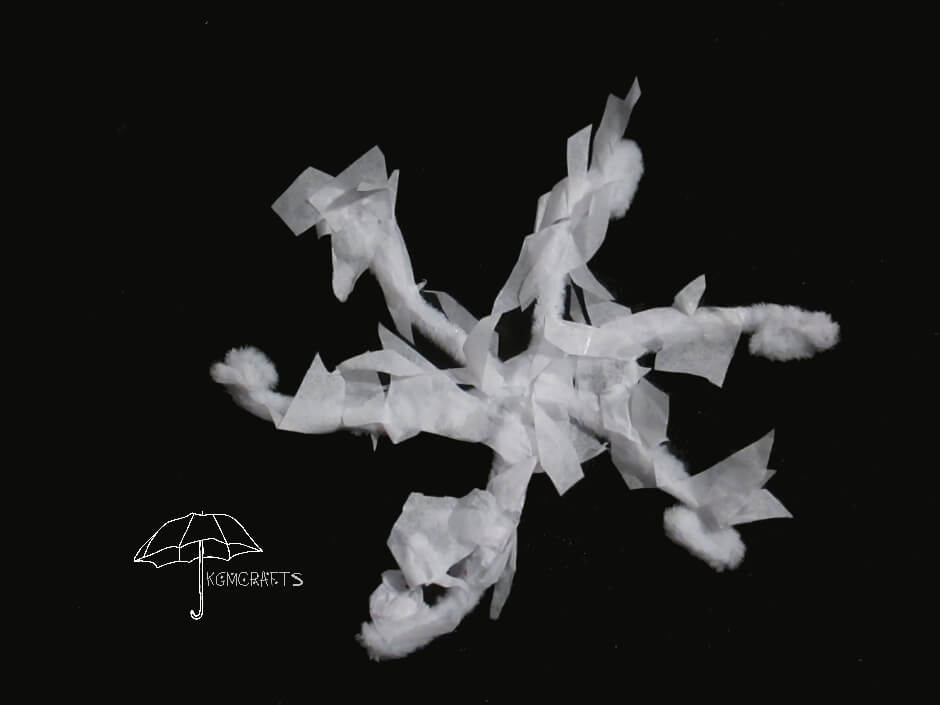white tissue made into a snowflake pipe cleaner and tissue snowflake